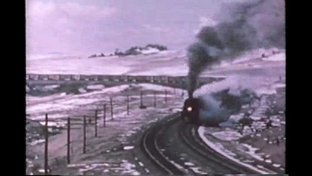 Smoking steam locomotive on curve
