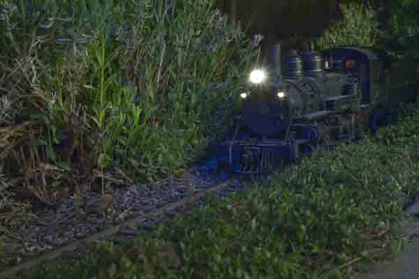 A model steam engine with its headlight on