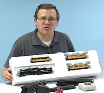 Cody Grivno holding a box of model trains