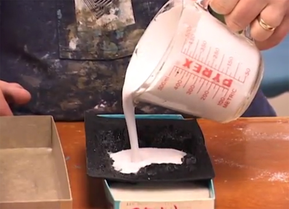 Pouring Hydrocal into a rubber rock mold