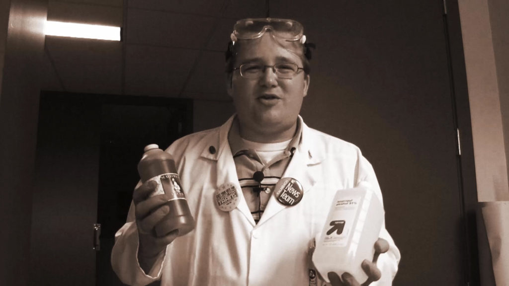 black-and-white photo of Cody Grivno wearing a white jacket and safety goggles on head