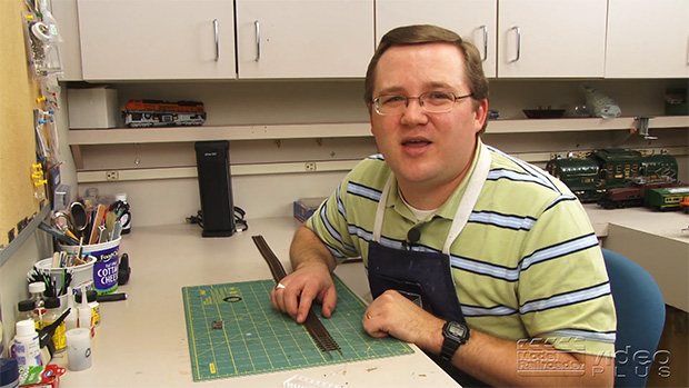 Cody Grivno sitting at his workbench