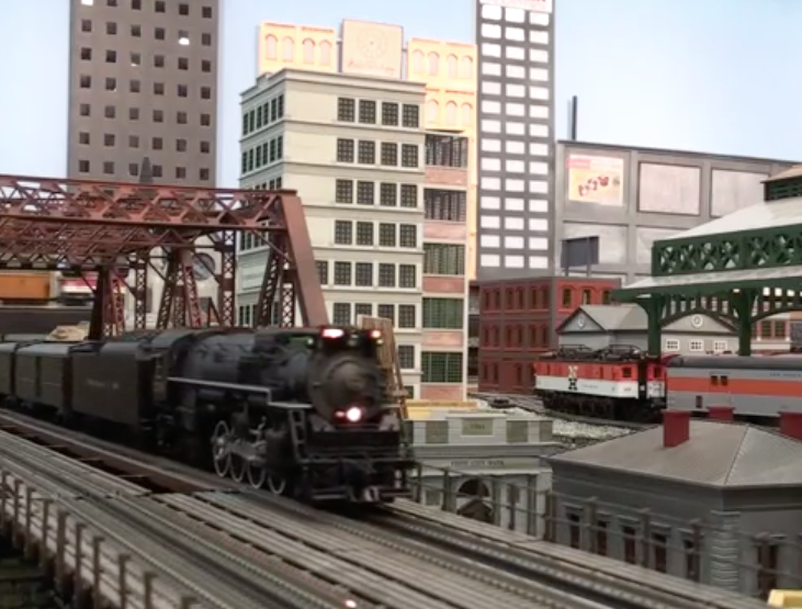 A model train passing through a bridge