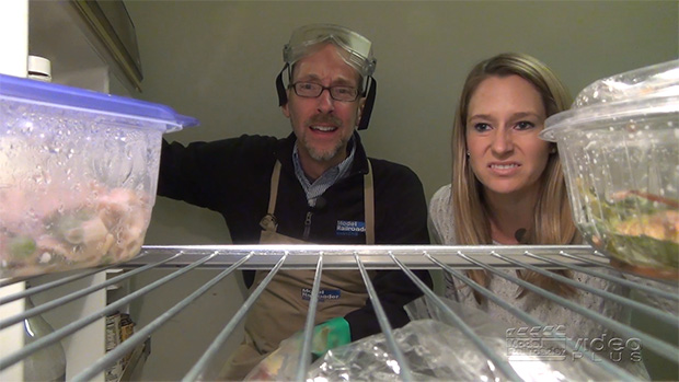 David Popp and Jenny Freeland looking into a refrigerator