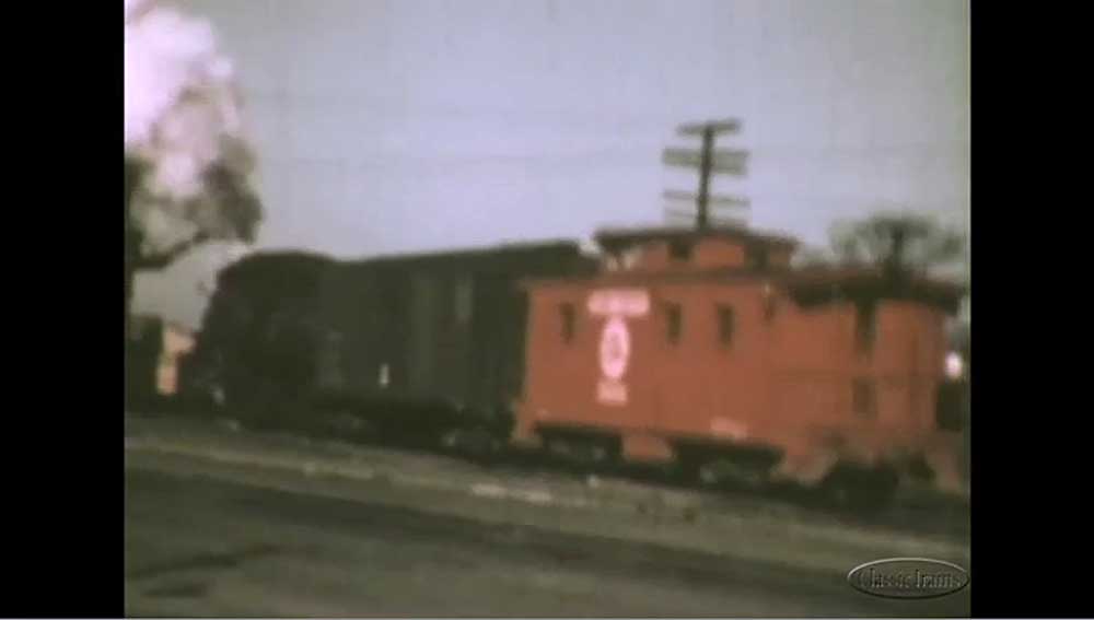 Red caboose on rear of freight train