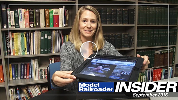 Jenny Freeland in library with books and tablet