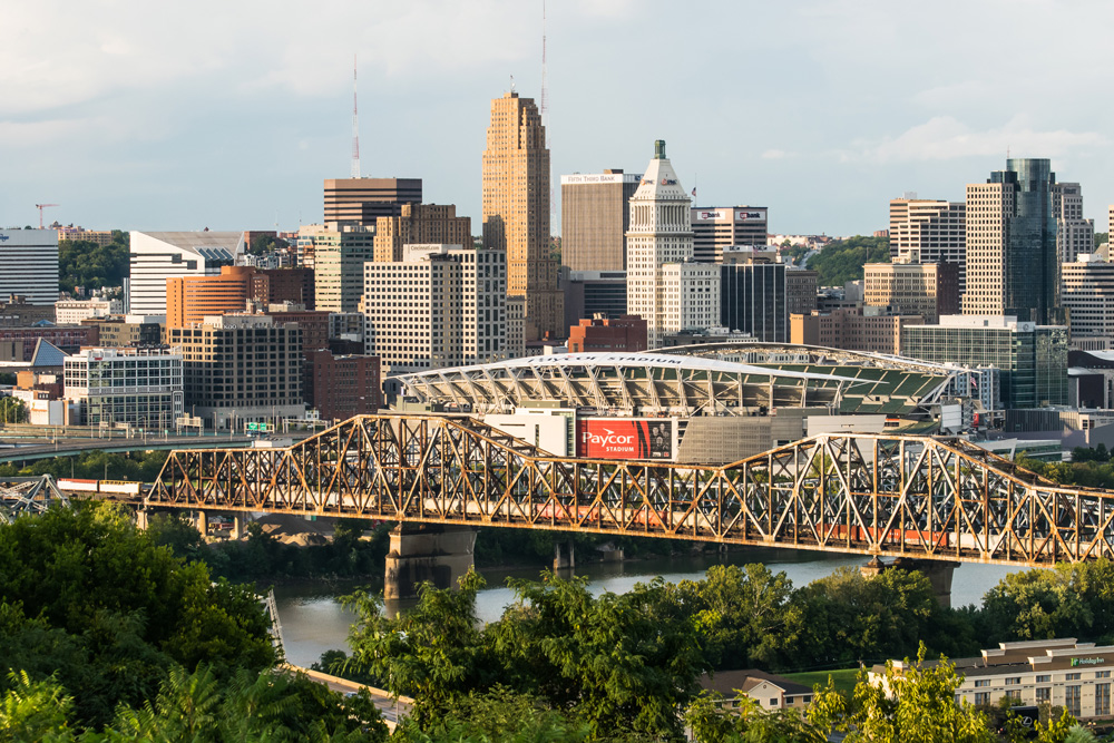 city buildings with train on bridge