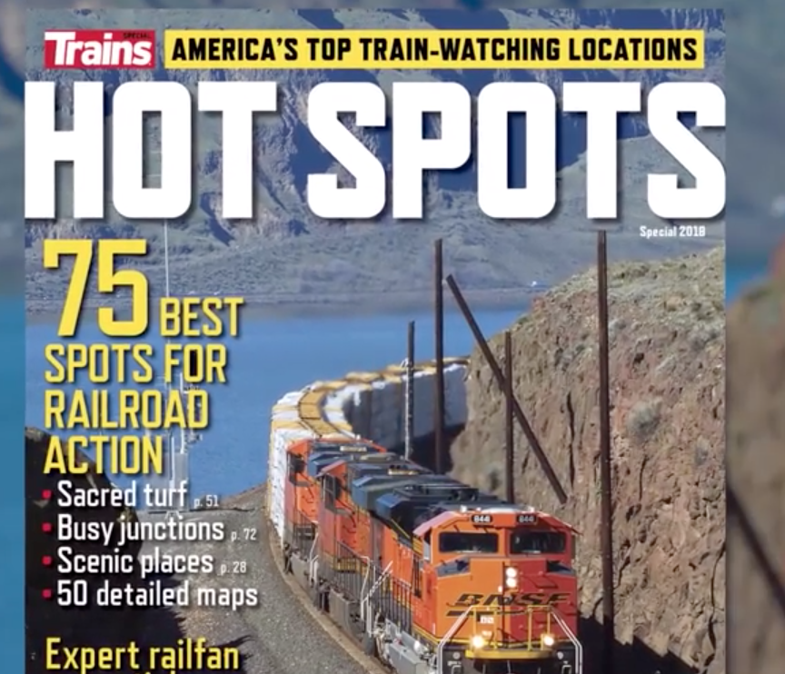 Top portion of a magazine cover showing a n orange locomotive.