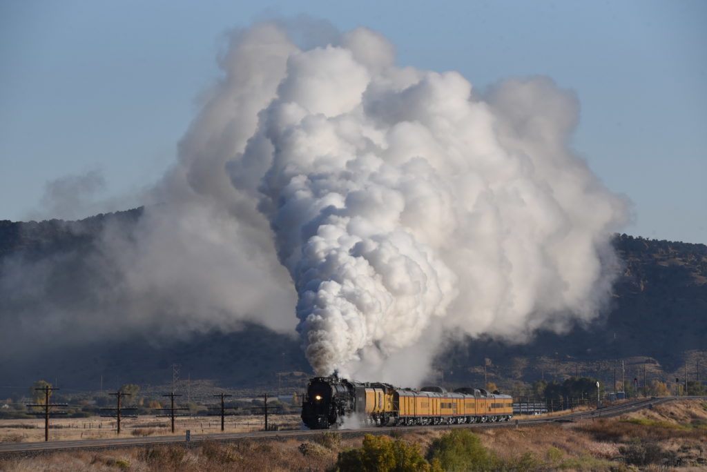 A steam engine with a huge plume of steam over it