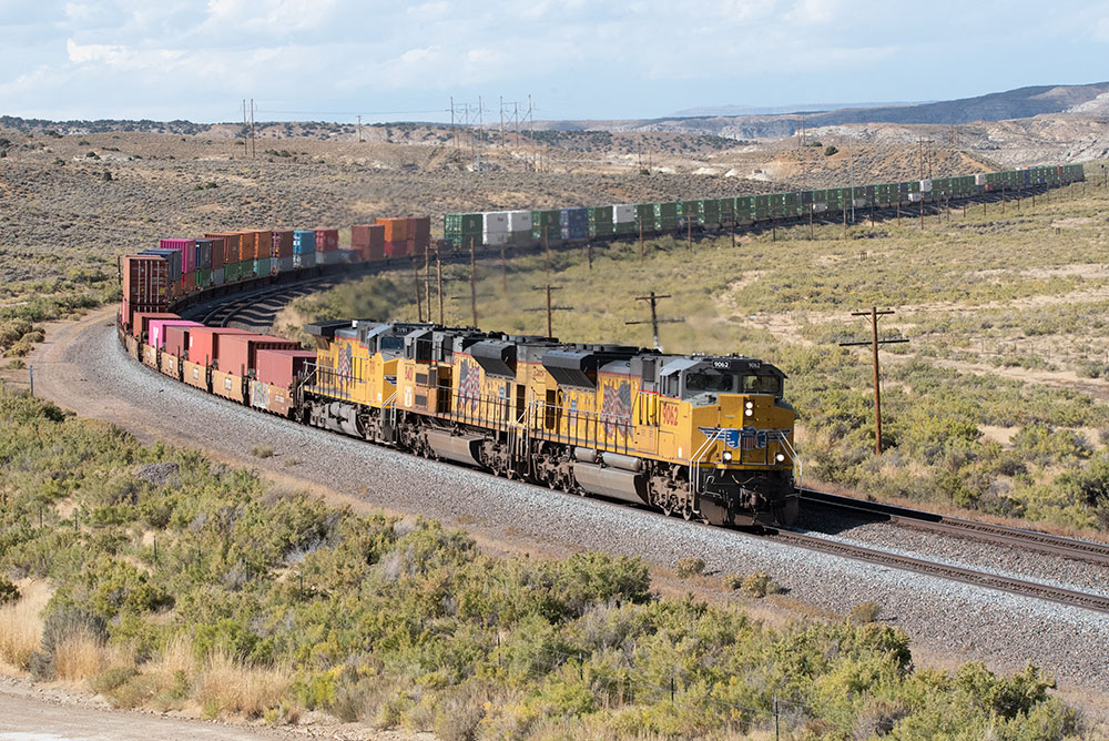 A diesel engine pulling a long train around a curve