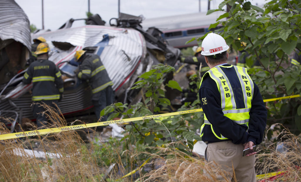 Man looking at wreckage of passenger trian