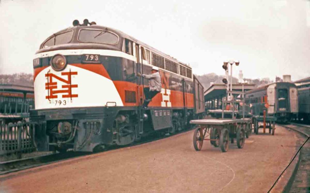 Diesel locomotive by station platform with baggage cart