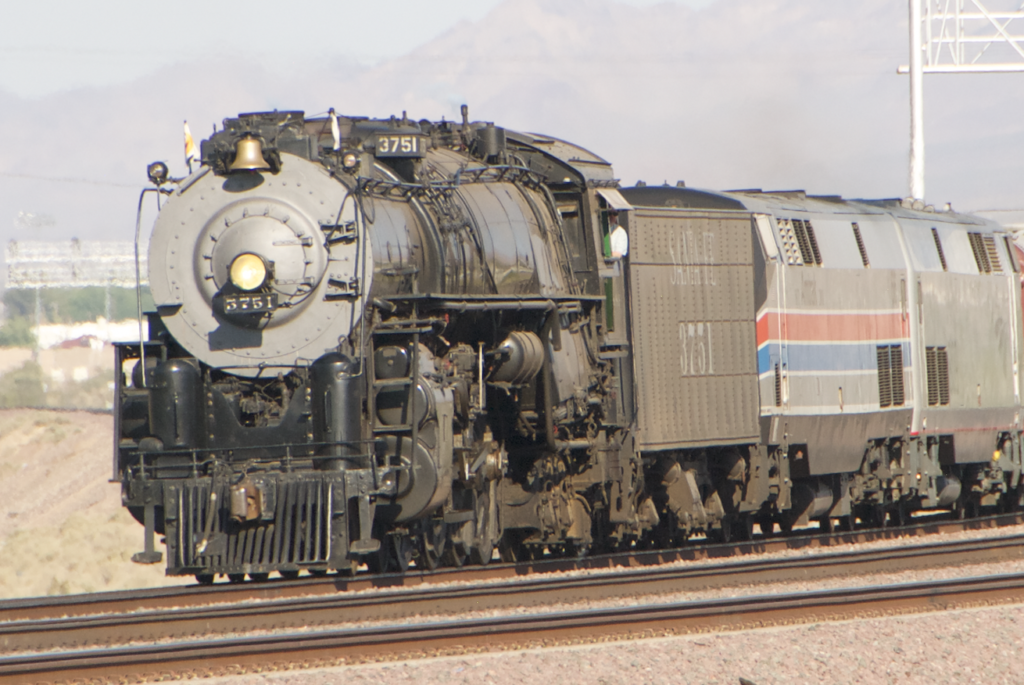 steam locomotive and Amtrak engine pulling train