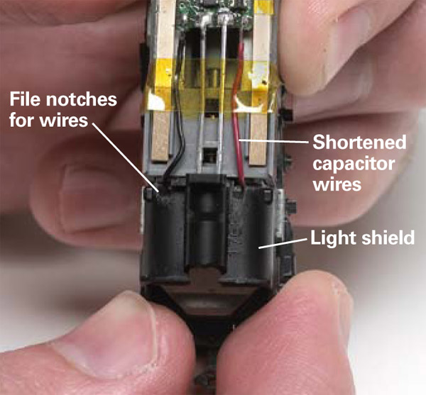 For the shell fit properly file small notches into the light shield so the capacitors wires can pass through it