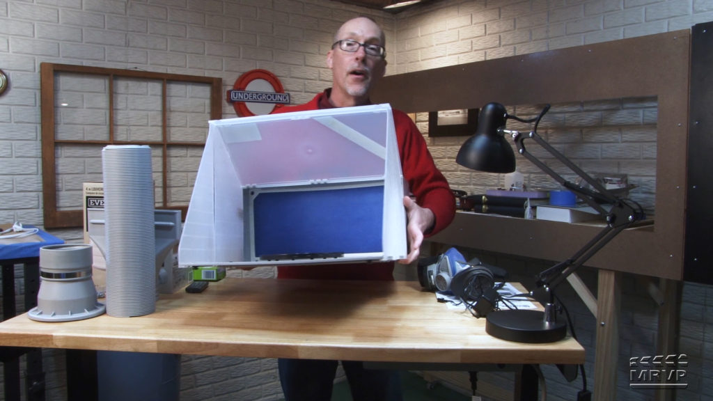 David Popp holding a spray booth.