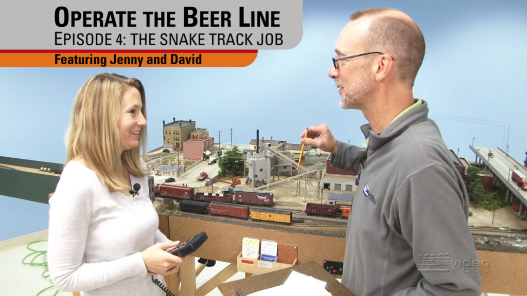 David Popp and Jenny Maaske in front of a model railroad.