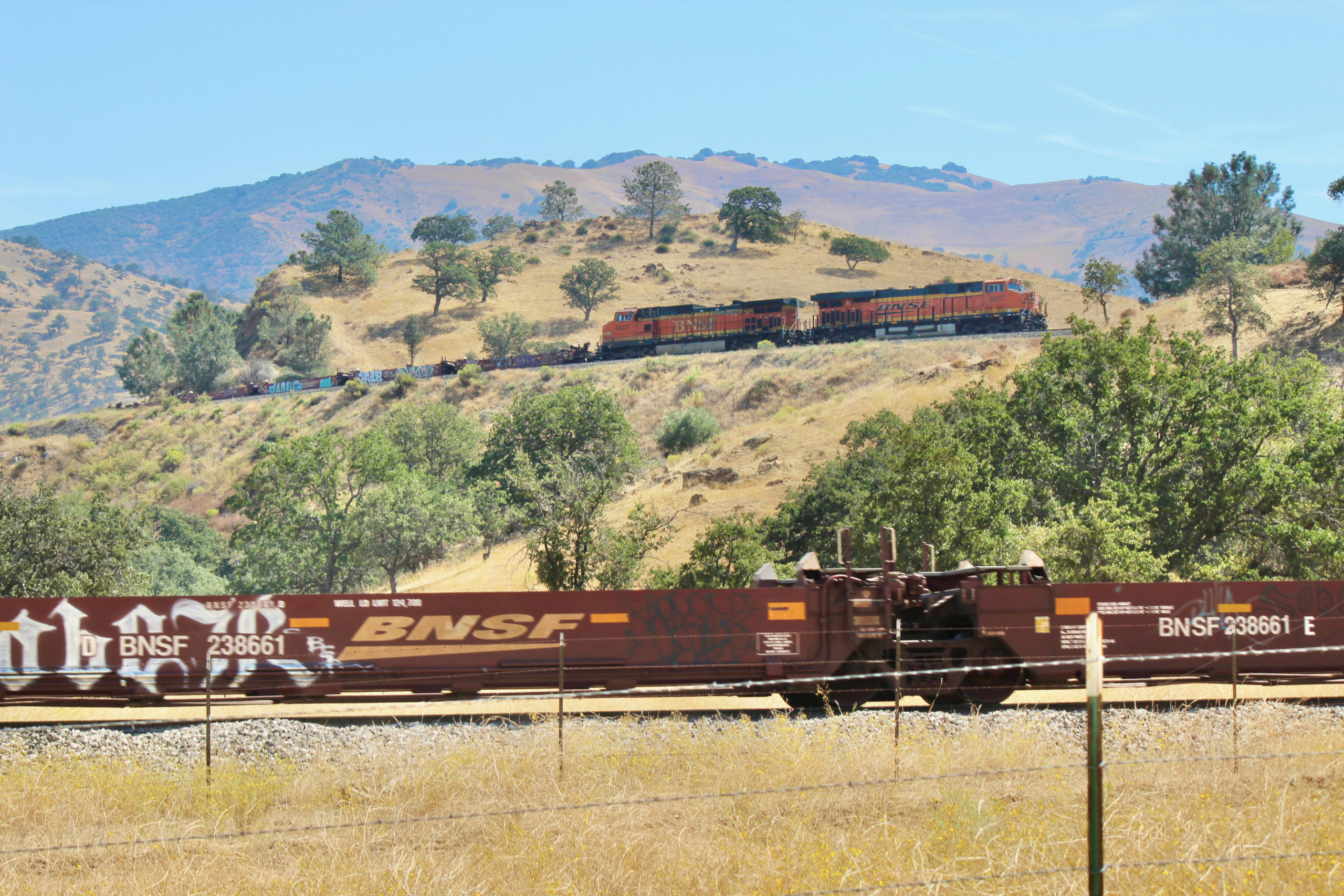 A BNSF Railway baretable train ascends Tehachapi Loop in California in September 2019.