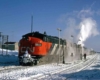 a diesel passenger train by a snowy field