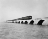 a passenger train on a viaduct over water