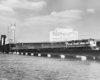 a passenger train on a bridge crossing water