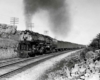 Smoking steam locomotive with passenger train