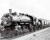 Steam locomotive with passenger train by semaphore signal