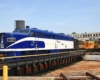 A blue and white train in a turntable