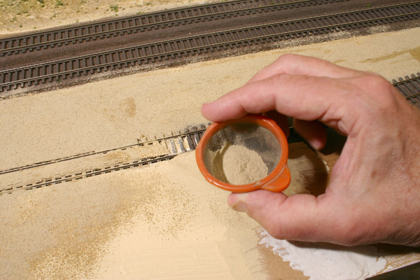 On his diorama, Paul built up a gravel lot using layers of cardboard. He used real powdered dirt as ground cover for the road surface.