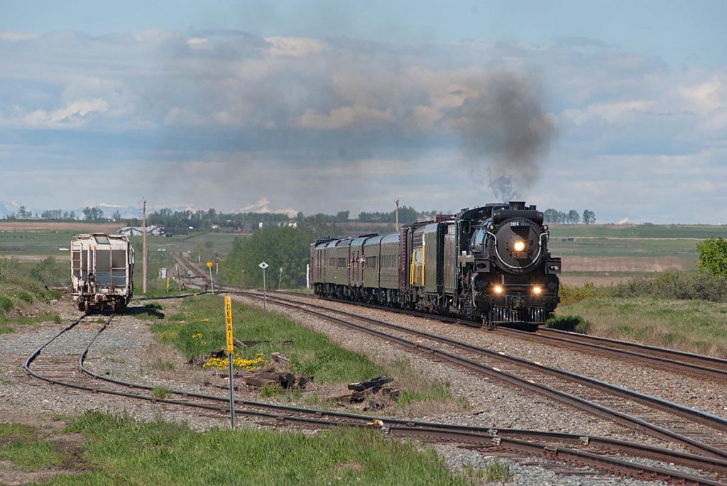 Steam locomotive with short train on prairie