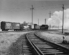 Steam locomotive with caboose, boxcar, and flat car