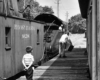 Boy watches railroaders work