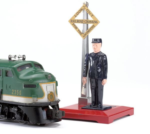 green and silver locomotive with model of figure