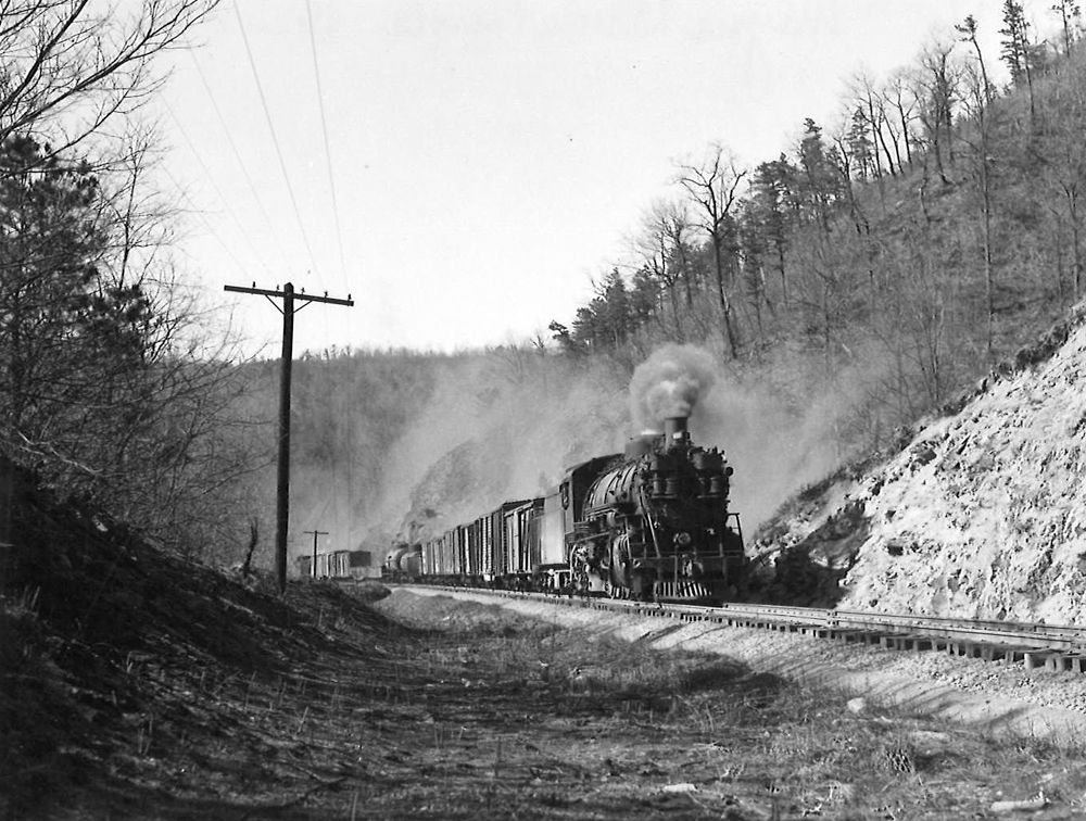 A black and white photo of K-4 2-8-2 Mikado heading down the tracks