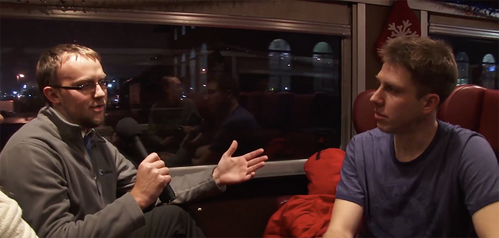 Two men speak inside a passenger car on the route of the Canadian Pacific Holiday Train.