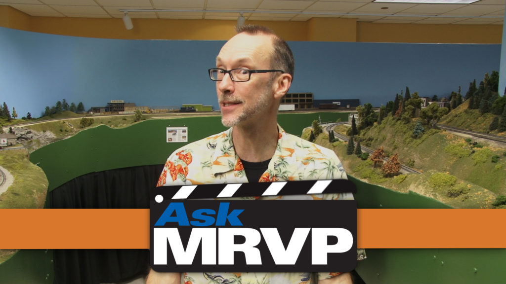 David Popp wearing a Hawaiian shirt and standing in the MR&T layout room at Kalmbach Media.
