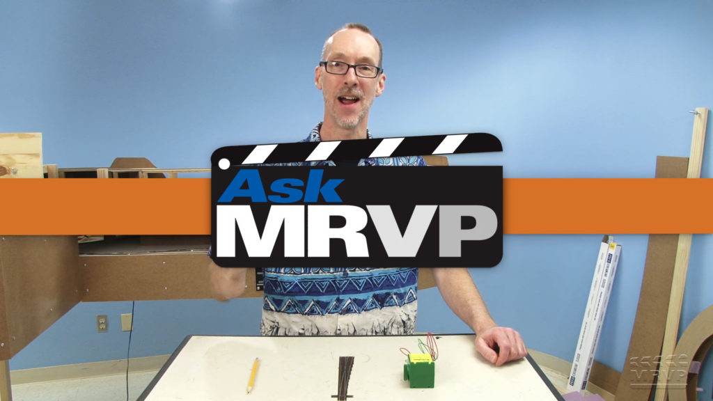 David Popp standing at a table in the Model Railroader workshop introducing a video.