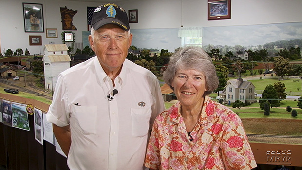 Ray and Renee Grosser standing in front of their O gauge layout