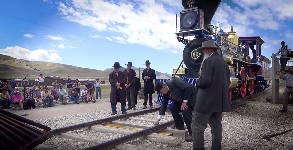 Actors surround a steam locomotive for a dramatization.