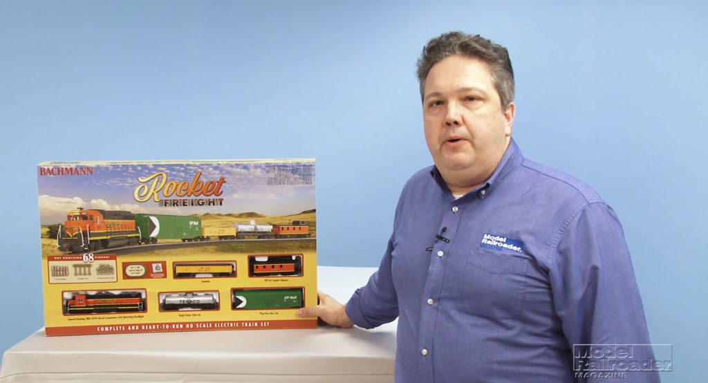 Dana Kawala standing next to a Bachmann Trains HO scale Rocket Freight set