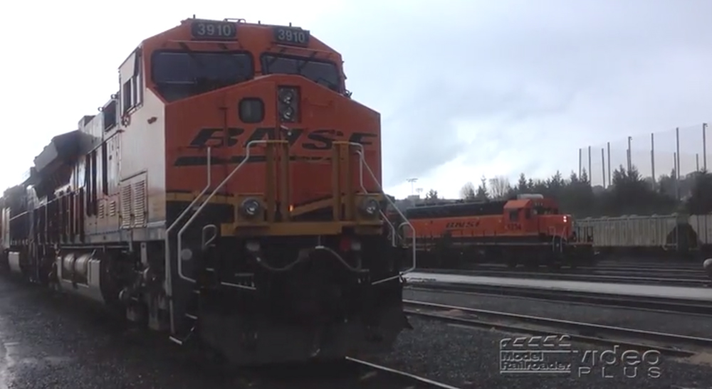 An orange-painted BNSF Railway locomotive in a yard.