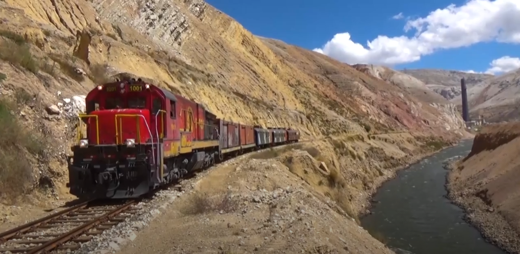 A GE C30-7 pulls a mix of passenger and freight cars on the Ferrocarril Central Andino railroad branch in Peru
