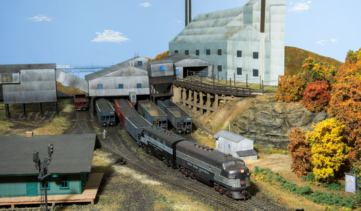a model train pulling coal hoppers