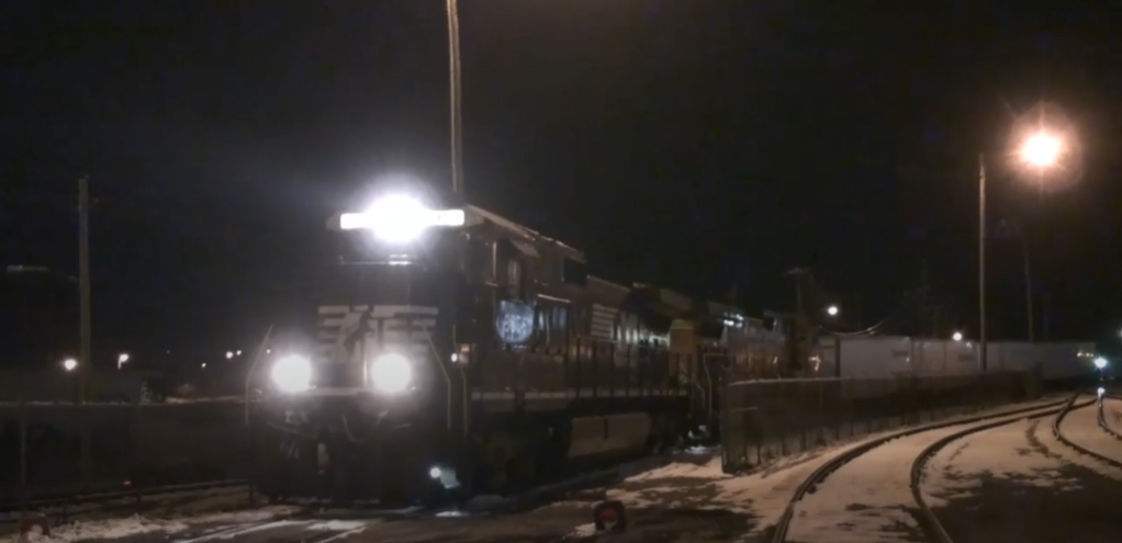 Locomotive with its headlight on at night