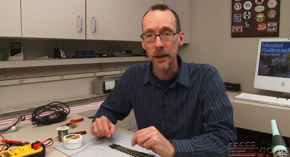 David Popp sitting at workbench in the Model Railroader workshop