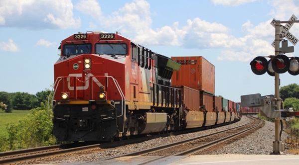 Container train with red and black locomotive