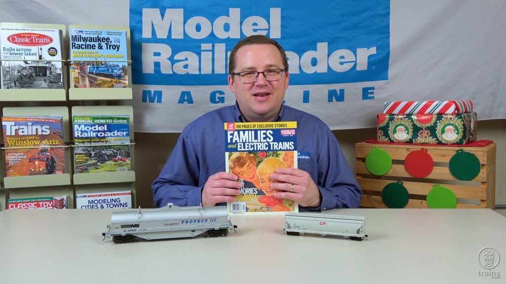 Cody Grivno holding a copy of CTT special issue Families and Electric Trains