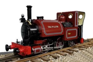 Red steam locomotive on tracks