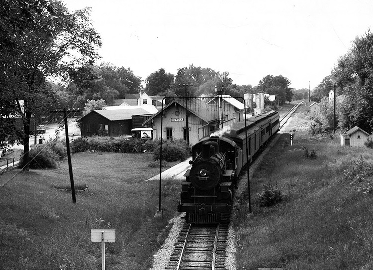 Ann Arbor 4-4-2 steam locomotive with passenger train at station.