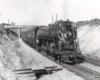 A 4-8-4 steam locomotive moving at speed.