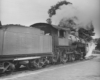 An oblique rear view of a 2-6-0 steam locomotive and most of its tender.